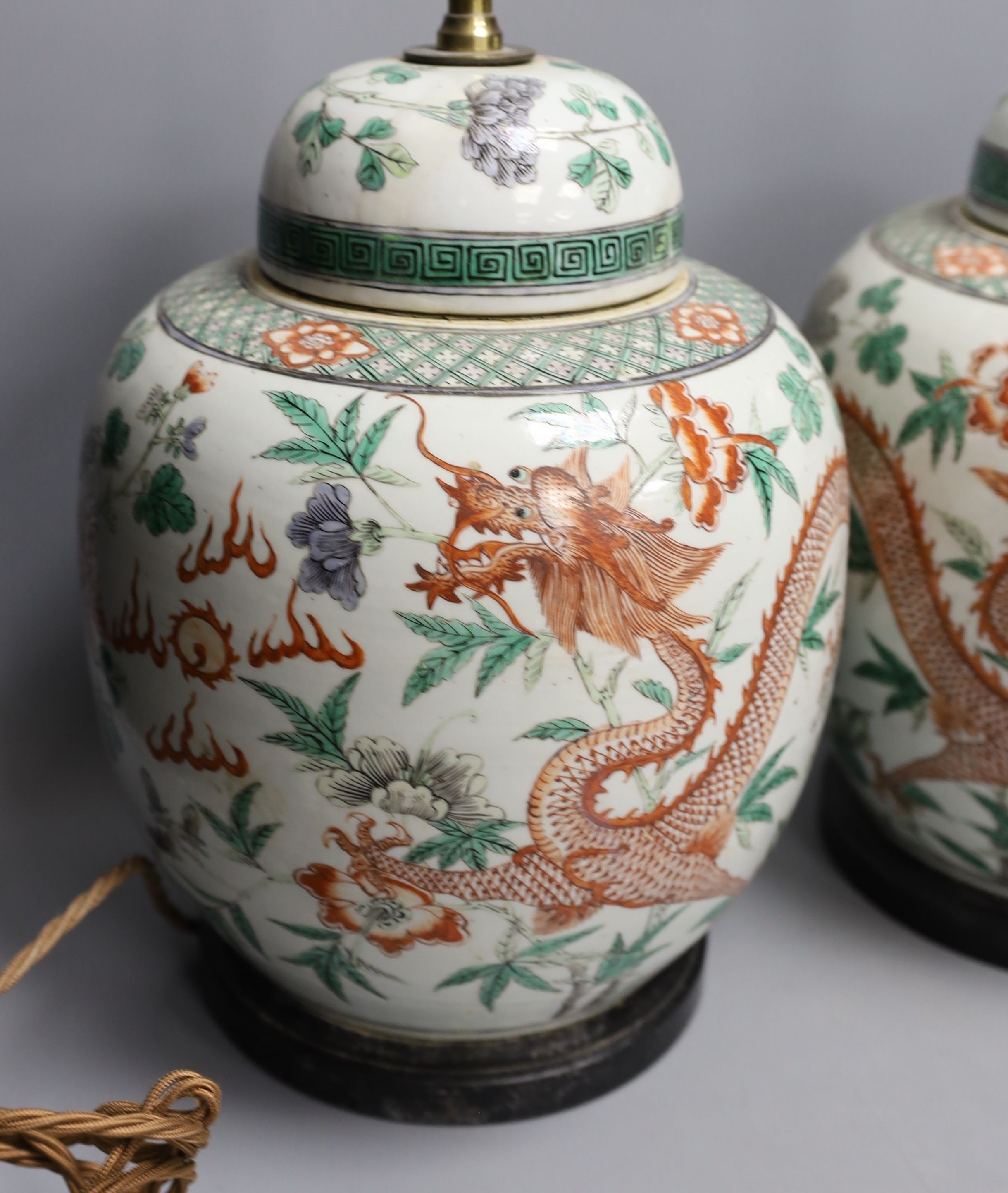 A pair of 19th century Chinese famille verte’dragon’ jars and covers (drilled and converted to lamps) - 53cm high